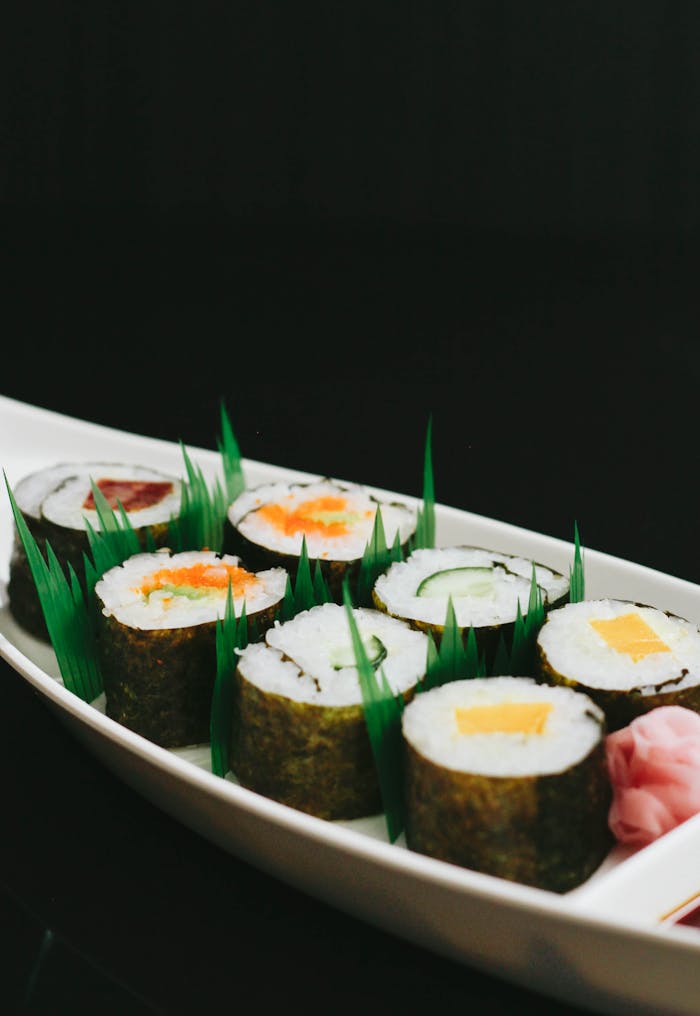 Close-up of assorted sushi rolls on a decorative plate, perfect for lunch or dinner.